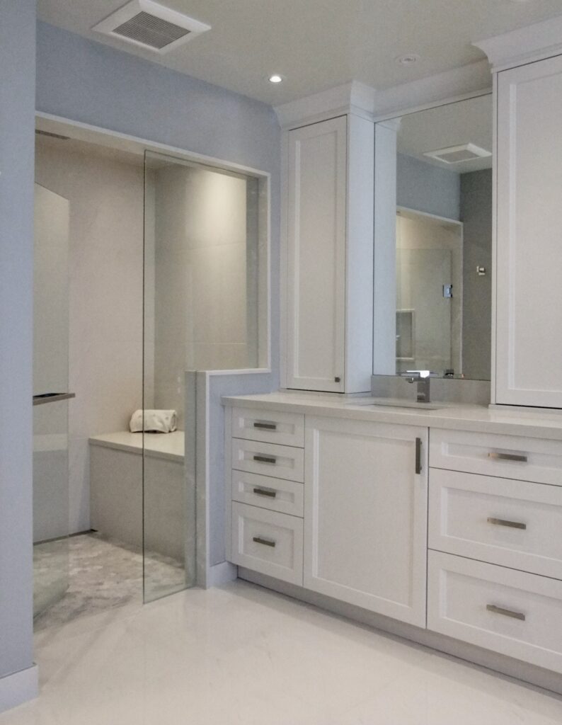 A white color luxury washroom with glass wall