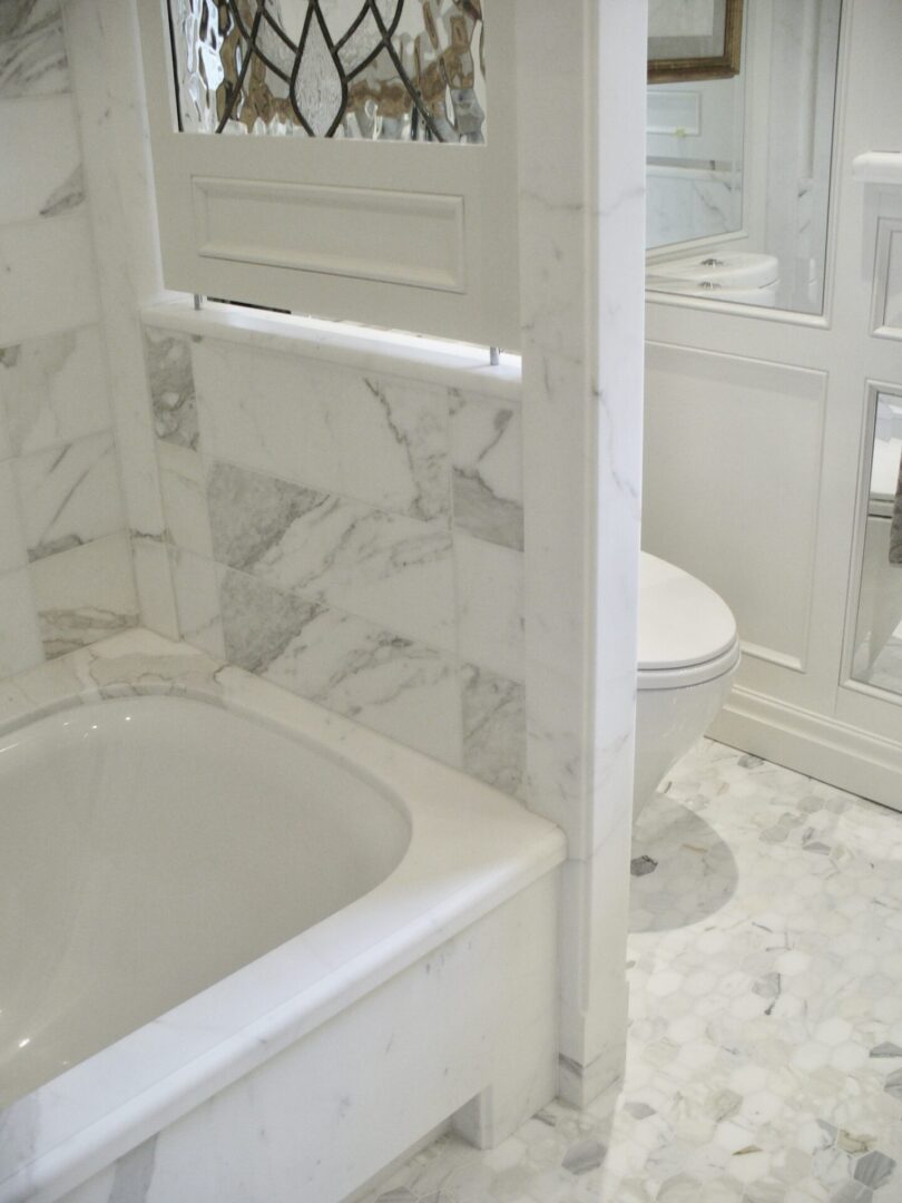 A white color, beautiful washroom with a bath tub