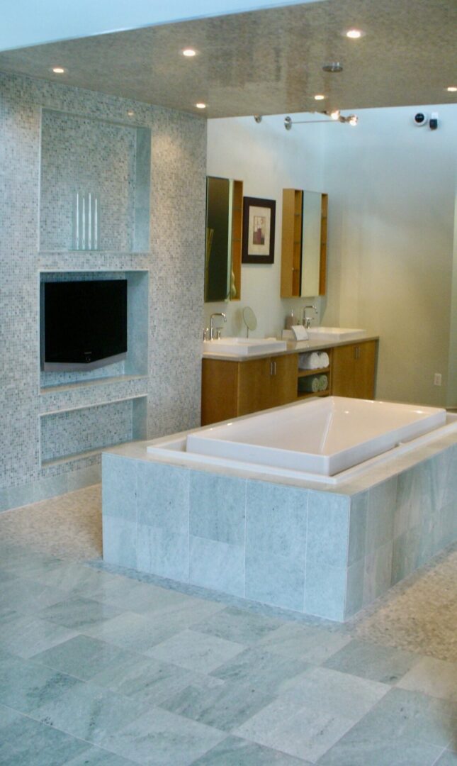 A beautiful customizes washroom with basins and television.