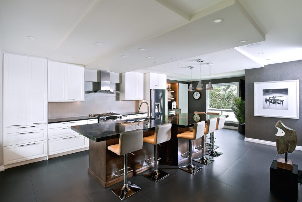 A kitchen with predominantly white, gray, and black hues