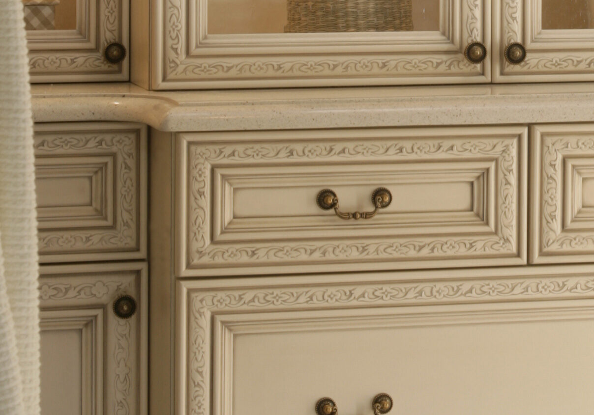 A cupboard set with handles on a wall